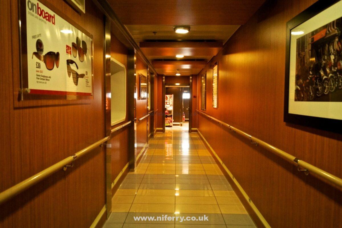 Link corridor between the rear an front areas of passenger accommodation. This picture is taken looking towards the stern of the ship and so the passenger cabins on this deck are behind the panelling on the right. © Niferrysite