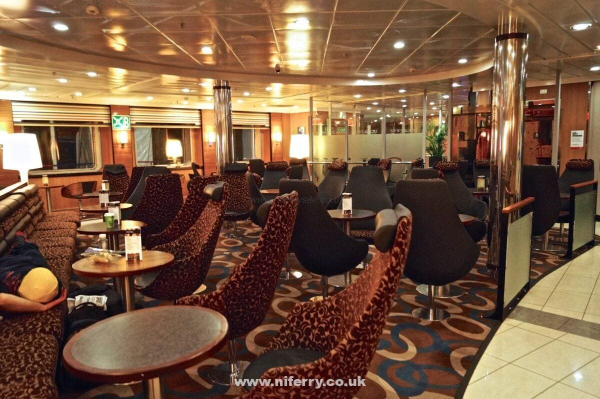 Continuing our walk towards the bow (front) of the ship, we next pass through one of the main seating areas, the Barista Coffee Shop. This view is taken from the other side looking towards the news room (the glass panels in the background). © NIFerrySite.