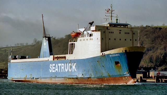 Riverdance is pictured looking a little worse for wear while leaving Curran Quay at Larne to allow another vessel to use the berth. Taken when Seatruck temporarily moved their service from Warrenpoint to Larne due to technical problems with the linkspan at Warrenpoint. Albert Bridge [CC BY-SA 2.0], via Geograph