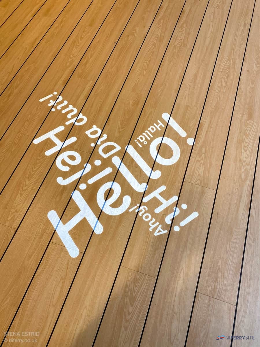 Close-up of the message projected onto the floor from the deckhead above in front of guest services.  © NIferry.co.uk